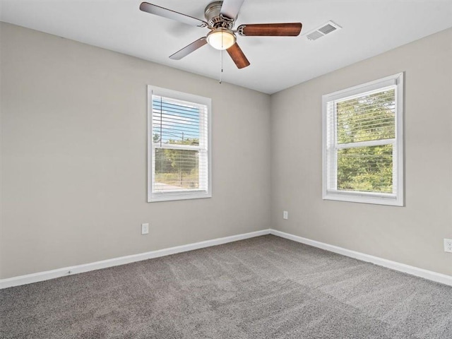 carpeted spare room featuring ceiling fan