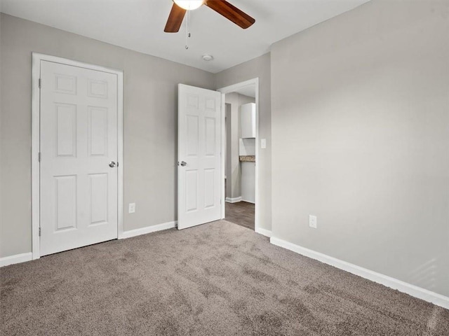 unfurnished bedroom featuring ceiling fan and carpet floors