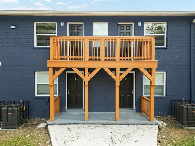 rear view of property with central AC unit