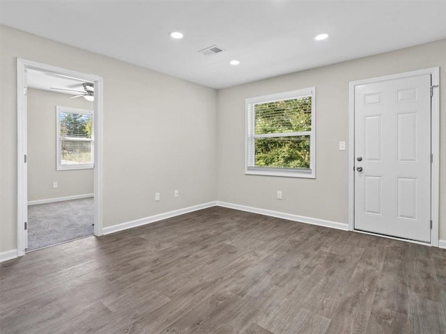 unfurnished room with ceiling fan and dark hardwood / wood-style floors