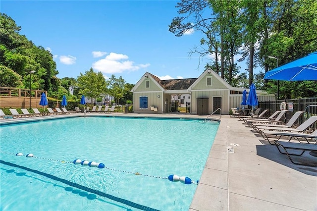 community pool featuring fence and a patio area