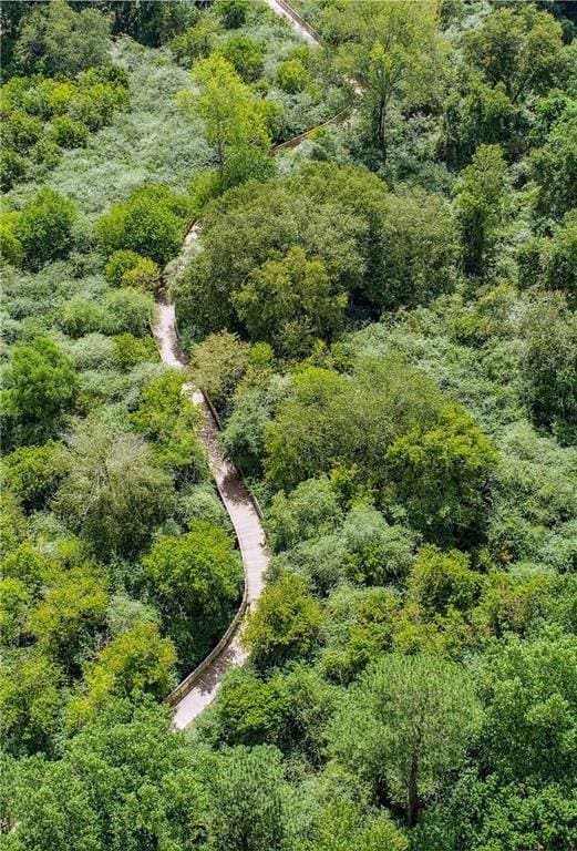 birds eye view of property featuring a wooded view