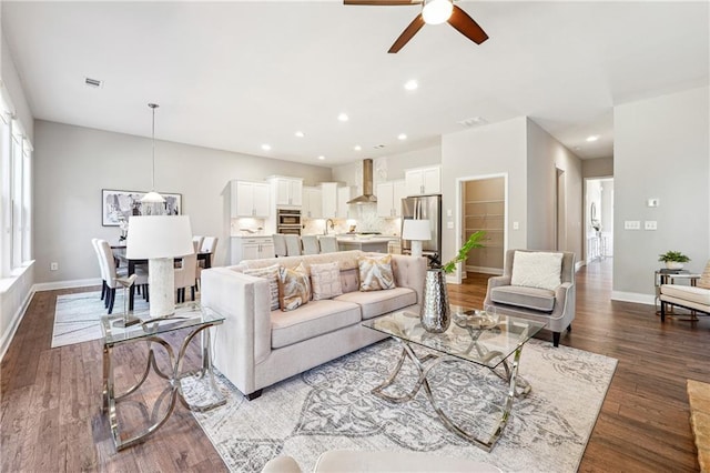 living room featuring recessed lighting, baseboards, and wood finished floors