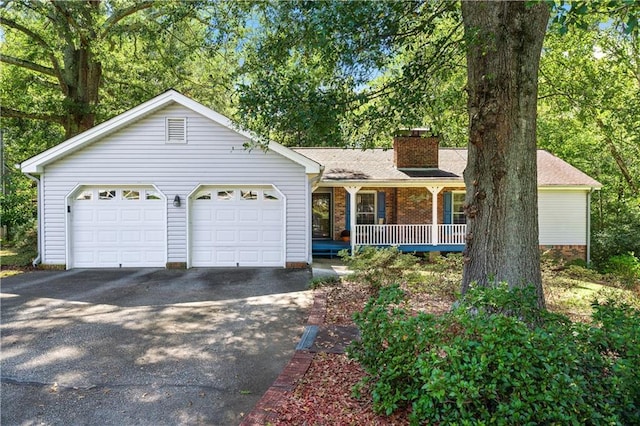 ranch-style house featuring a porch and a garage