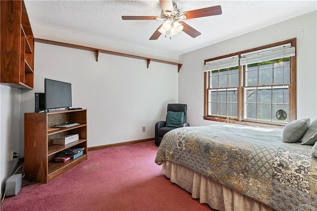 bedroom with ceiling fan, carpet floors, and a textured ceiling