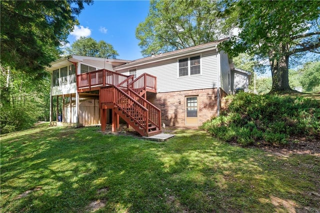 rear view of house with a deck and a yard