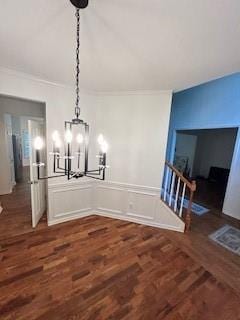 unfurnished dining area with a chandelier and dark wood-type flooring