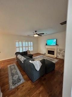 living room featuring ceiling fan and dark hardwood / wood-style flooring