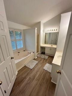 bathroom featuring shower with separate bathtub, wood-type flooring, lofted ceiling, and vanity