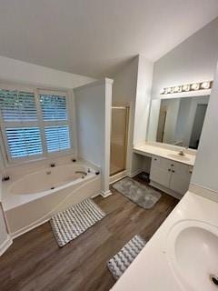 bathroom featuring lofted ceiling, plus walk in shower, vanity, and hardwood / wood-style floors