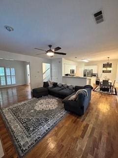 living room featuring hardwood / wood-style floors and ceiling fan