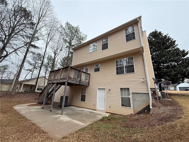 back of property with stairs, a patio, a wooden deck, and central air condition unit