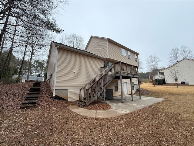 back of house featuring stairs, a patio area, a wooden deck, and central air condition unit