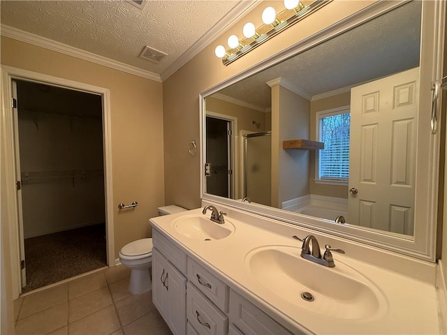 bathroom featuring tile patterned flooring, a sink, a shower stall, and a textured ceiling