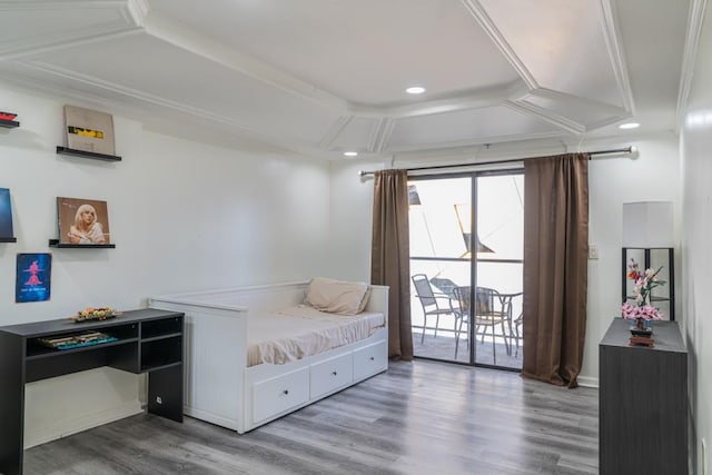 sitting room with crown molding and wood-type flooring