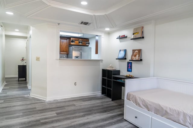 unfurnished bedroom with crown molding, stainless steel fridge, and hardwood / wood-style floors