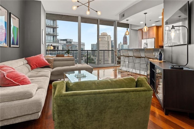 1080 Peachtree St NE Unit 2108, Atlanta, GA 30309 - living room featuring wood finished floors, a skyline view, a chandelier, and floor to ceiling windows