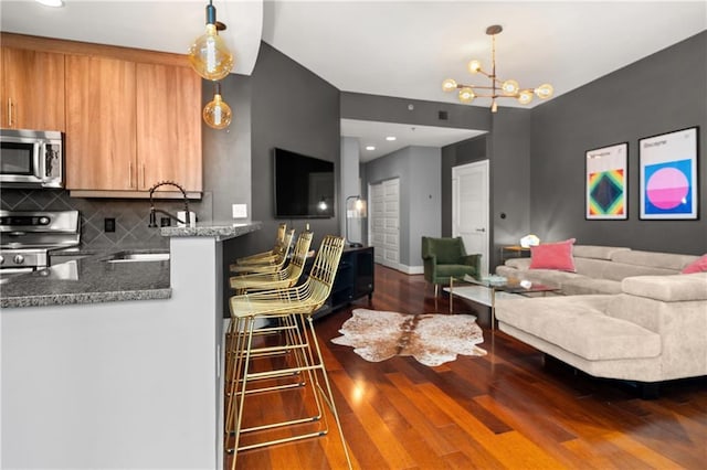 1080 Peachtree St NE Unit 2108, Atlanta, GA 30309 - living area with dark wood finished floors, a chandelier, and recessed lighting