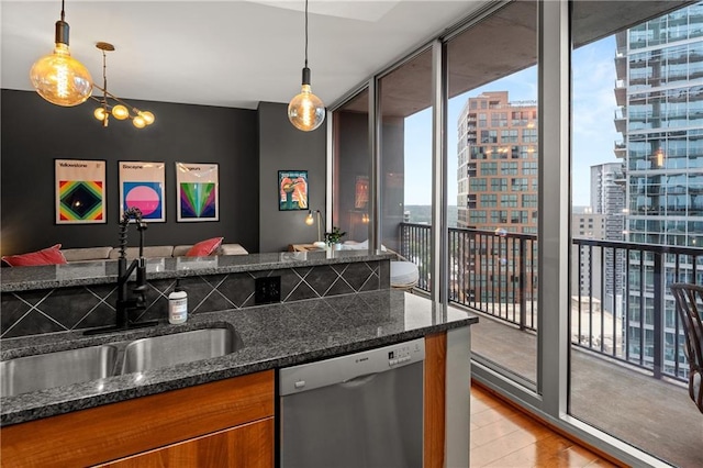 1080 Peachtree St NE Unit 2108, Atlanta, GA 30309 - kitchen featuring stainless steel dishwasher, brown cabinets, floor to ceiling windows, light wood-style flooring, and dark stone counters