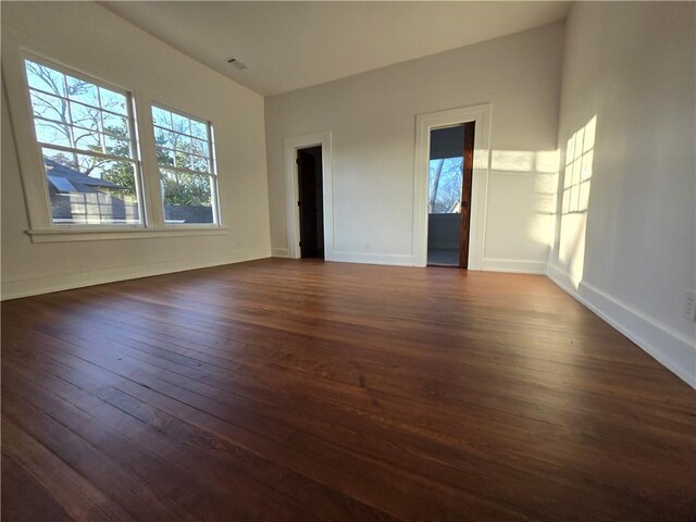 spare room with dark hardwood / wood-style flooring