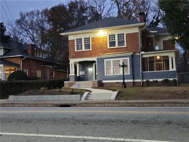 view of front of house featuring a sunroom