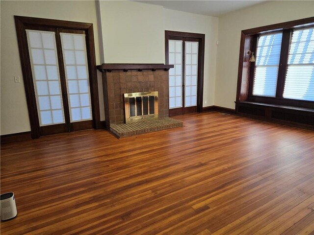 empty room featuring french doors and dark hardwood / wood-style floors