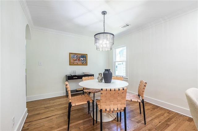 139 Sisson Ave NE, Atlanta, GA 30317 - dining room with a chandelier, wood finished floors, crown molding, arched walkways, and baseboards