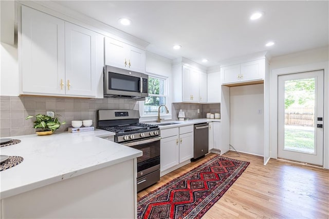139 Sisson Ave NE, Atlanta, GA 30317 - kitchen with appliances with stainless steel finishes, plenty of natural light, white cabinets, a sink, and recessed lighting