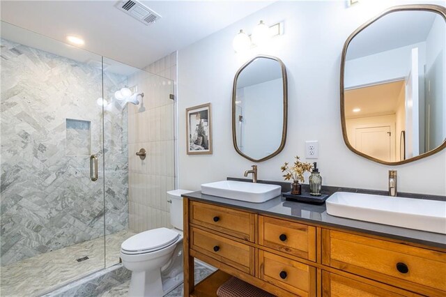 139 Sisson Ave NE, Atlanta, GA 30317 - bathroom with double vanity, a stall shower, toilet, and marble finish floors