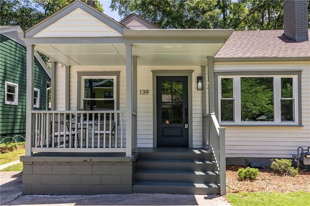 139 Sisson Ave NE, Atlanta, GA 30317 - property entrance featuring covered porch, a chimney, a shingled roof, and crawl space
