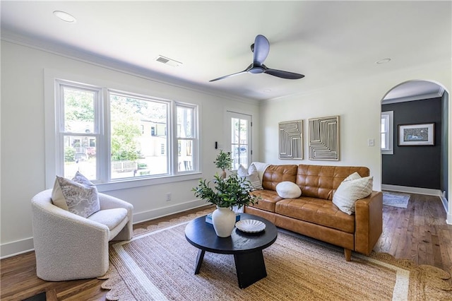 139 Sisson Ave NE, Atlanta, GA 30317 - living room with ceiling fan, baseboards, arched walkways, wood finished floors, and crown molding