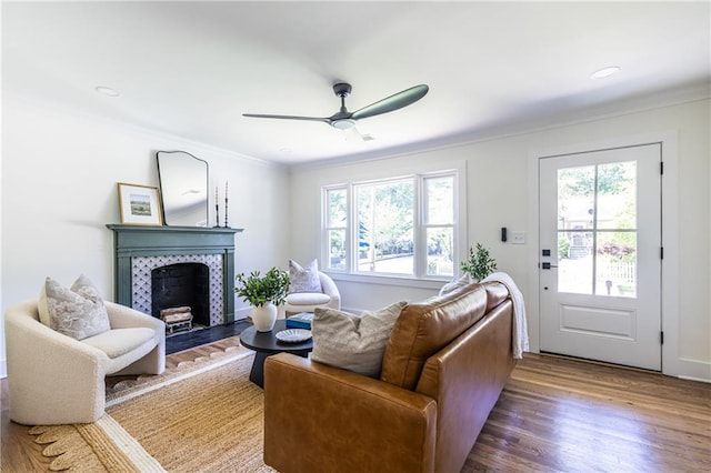 139 Sisson Ave NE, Atlanta, GA 30317 - living room featuring plenty of natural light, a tiled fireplace, crown molding, a ceiling fan, and wood finished floors