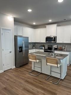 4258 SW Notting Hill Dr Unit 32, Atlanta, GA 30331 - kitchen with dark wood-type flooring, appliances with stainless steel finishes, white cabinetry, and a center island with sink