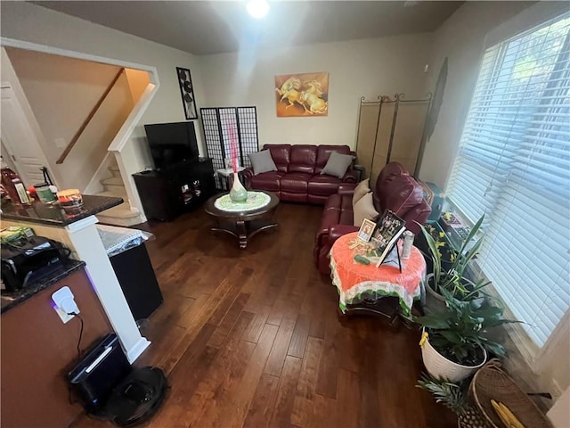 living area featuring stairs and dark wood-type flooring