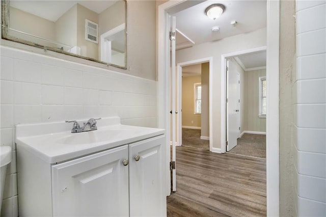 3449 Misty Valley Rd, Decatur, GA 30032 - bathroom featuring wood finished floors, vanity, baseboards, and ornamental molding