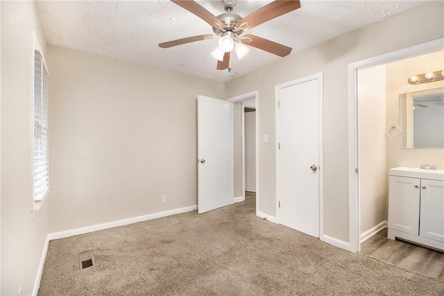 3449 Misty Valley Rd, Decatur, GA 30032 - unfurnished bedroom with carpet floors, a textured ceiling, baseboards, and a ceiling fan