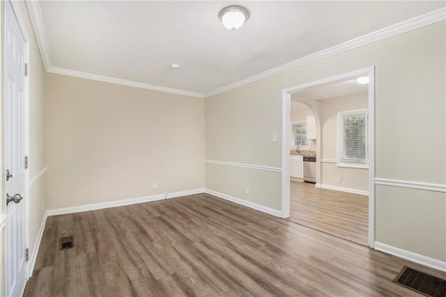 3449 Misty Valley Rd, Decatur, GA 30032 - empty room with wood finished floors, ornamental molding, baseboards, and arched walkways