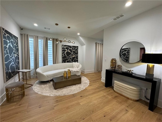 interior space with baseboards, light wood-type flooring, visible vents, and recessed lighting