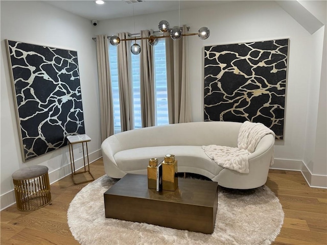 living area with recessed lighting, wood finished floors, visible vents, and baseboards