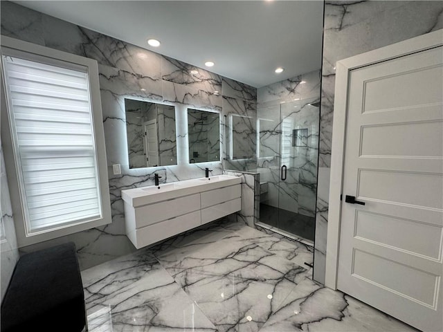 bathroom with marble finish floor, a marble finish shower, double vanity, recessed lighting, and stone wall