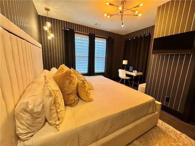 bedroom with visible vents and a notable chandelier