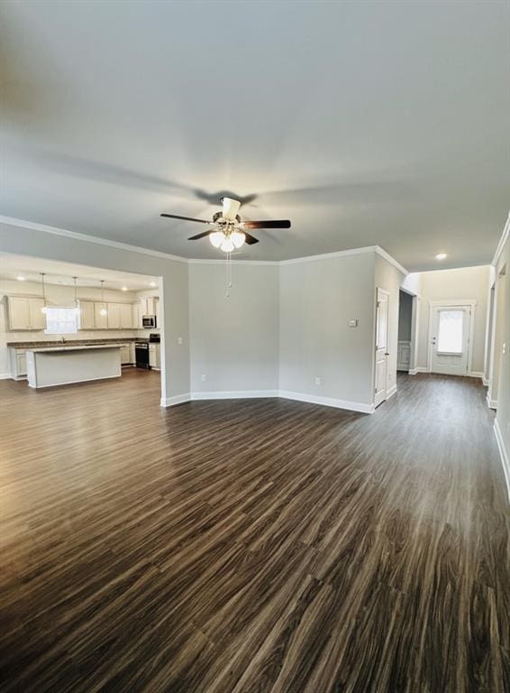 59 Observation Ct, Dallas, GA 30132 - unfurnished living room featuring dark wood-style floors, crown molding, baseboards, and ceiling fan