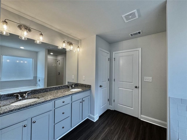 59 Observation Ct, Dallas, GA 30132 - bathroom with wood finished floors, a tile shower, baseboards, a garden tub, and double vanity
