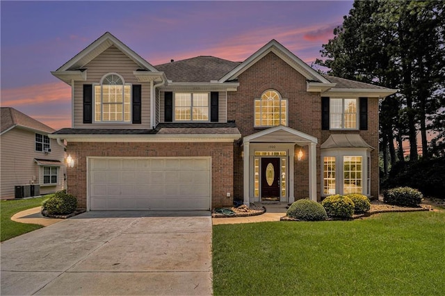 1900 Green Oak Cir, Lawrenceville, GA 30043 - view of front facade with concrete driveway, a front lawn, a garage, and brick siding