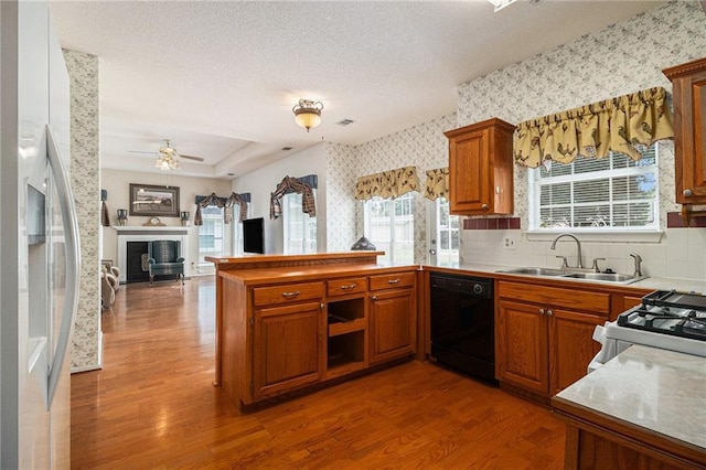 1900 Green Oak Cir, Lawrenceville, GA 30043 - kitchen with dishwasher, wood finished floors, wallpapered walls, stainless steel refrigerator with ice dispenser, and a peninsula
