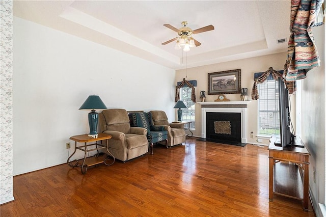 1900 Green Oak Cir, Lawrenceville, GA 30043 - living area with a raised ceiling, wood finished floors, ceiling fan, and healthy amount of natural light