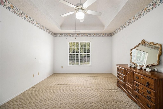 1900 Green Oak Cir, Lawrenceville, GA 30043 - spare room featuring carpet, a ceiling fan, a raised ceiling, and a textured ceiling