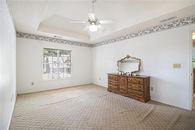 1900 Green Oak Cir, Lawrenceville, GA 30043 - carpeted bedroom with a textured ceiling, a ceiling fan, and a tray ceiling