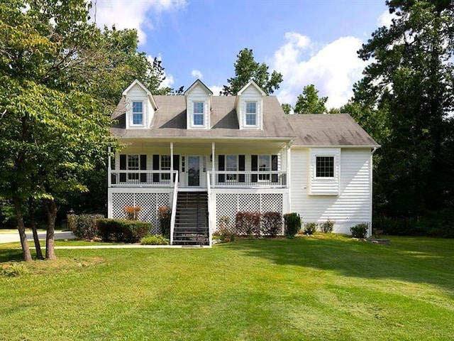 rear view of house featuring stairway, covered porch, and a lawn