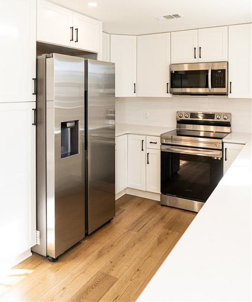 kitchen with sink, white cabinets, tasteful backsplash, and dishwasher